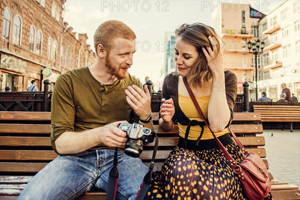 Caucasian couple checking photos on digital camera