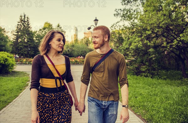 Caucasian couple holding hands in park