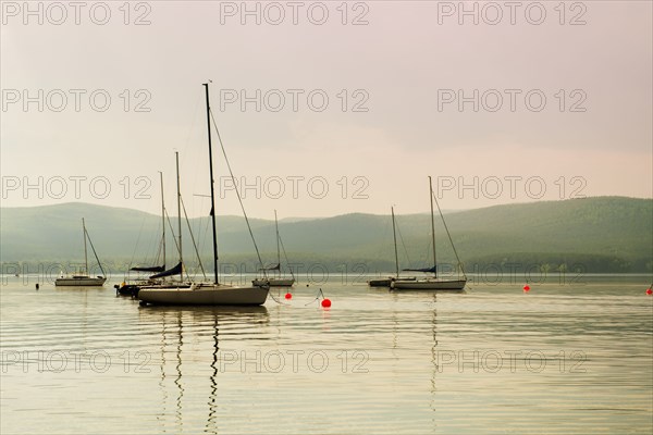 Boats floating in harbor