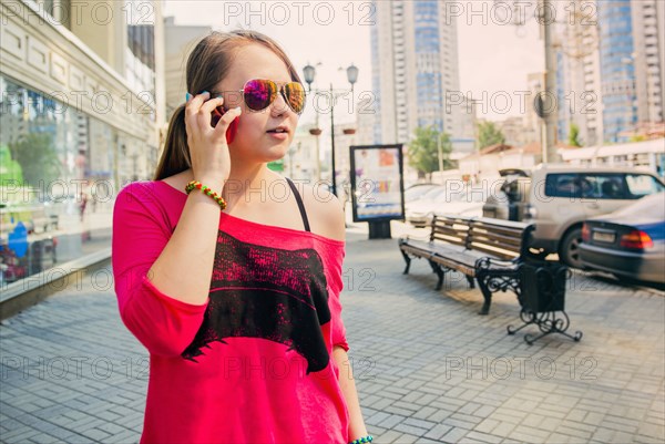 Caucasian teenage girl talking on cell phone