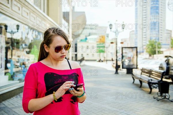 Caucasian teenage girl using cell phone