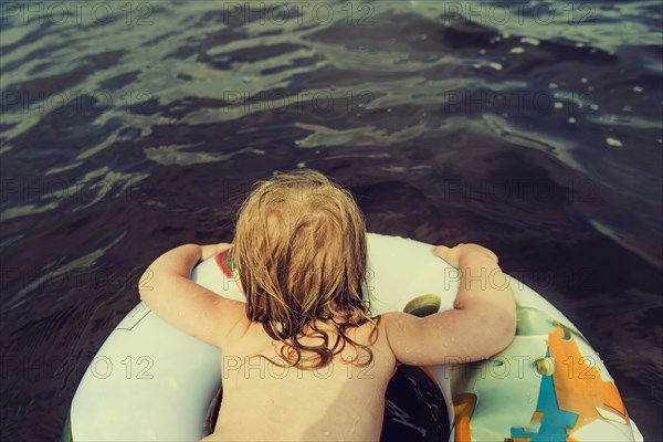 Caucasian girl swimming in lake