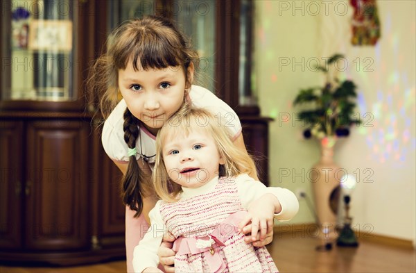 Caucasian sisters playing in house