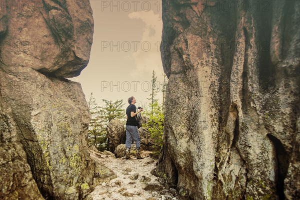 Caucasian hiker walking by remote cliffs