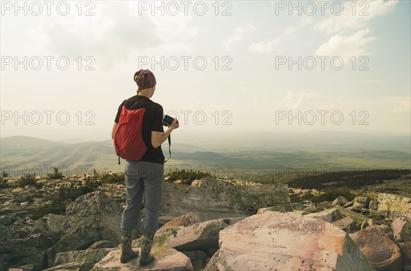 Caucasian hiker standing on rocky hilltop