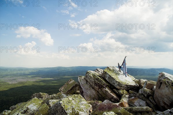 Banner on rocky hilltop in remote landscape