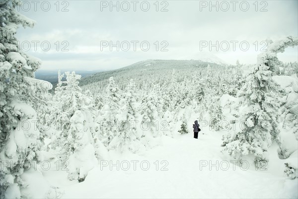 Caucasian hikers walking in snowy forest