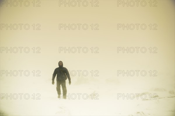 Caucasian hiker walking in snow