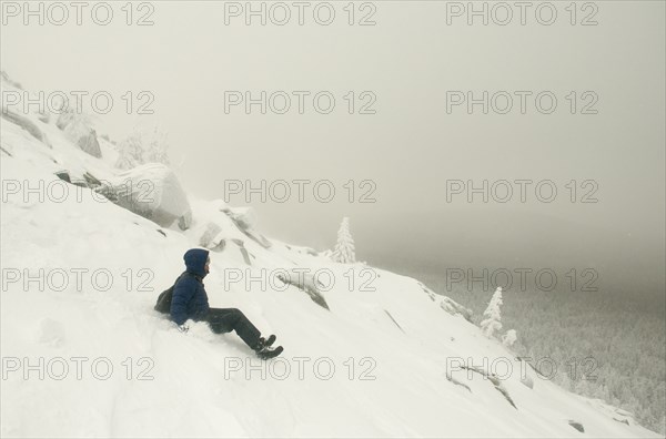 Caucasian man sledding on snowy mountain