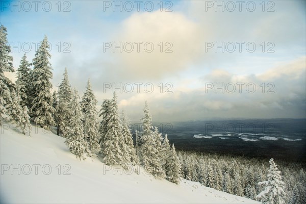 Snowy hillside over remote landscape