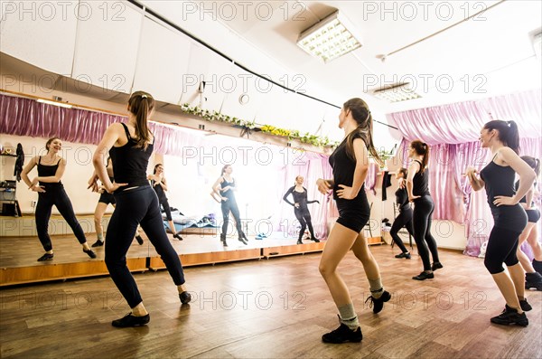 Caucasian dancers practicing in studio