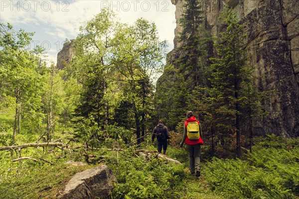 Caucasian hikers walking near mountain