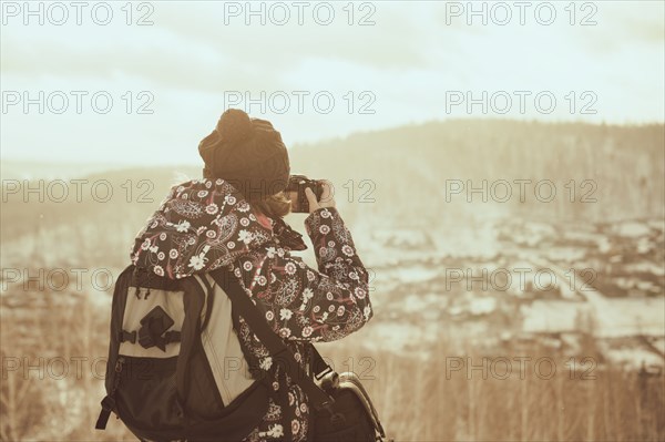 Caucasian woman photographing landscape