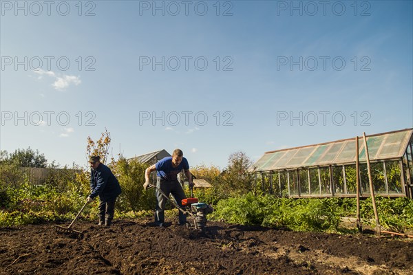 Caucasian men working in garden