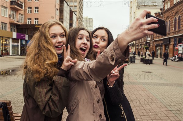 Caucasian women taking selfie outdoors