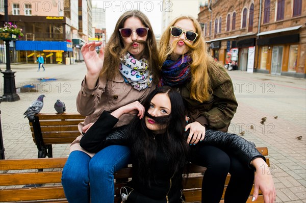 Caucasian women posing on bench