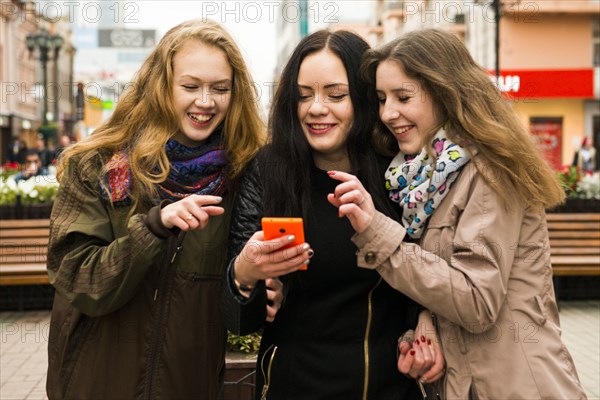 Caucasian women using cell phone outdoors