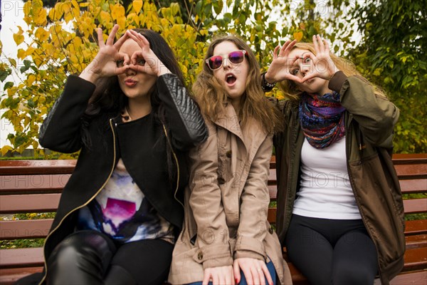 Caucasian women posing on bench