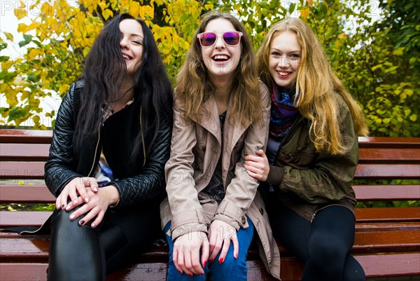 Caucasian women smiling on bench