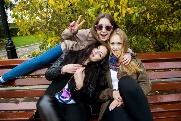 Caucasian women posing on bench