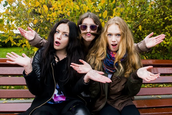 Caucasian women posing on bench