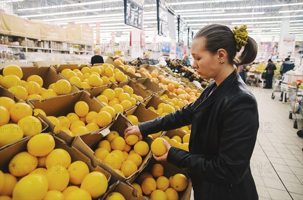 Caucasian woman shopping in grocery store