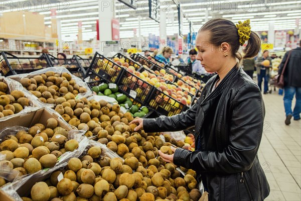 Caucasian woman shopping in grocery store