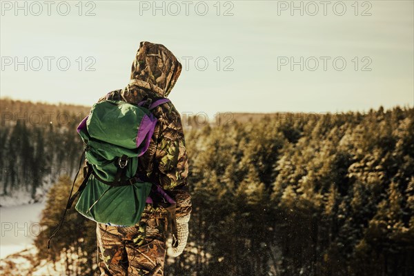 Caucasian hiker standing on hilltop