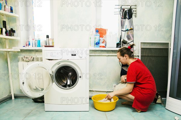 Caucasian woman hand-washing laundry