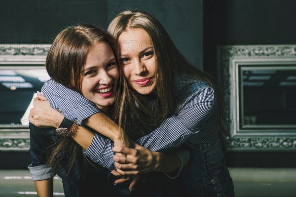 Women hugging in restaurant