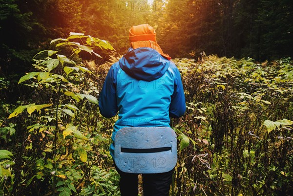 Caucasian woman walking in forest