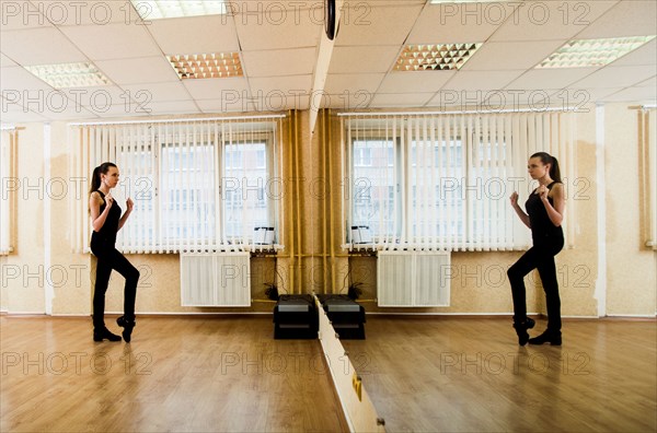 Caucasian dancer practicing in studio