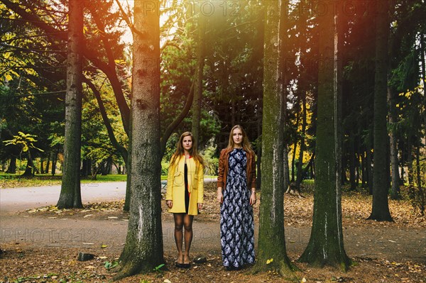 Caucasian women standing between trees in park