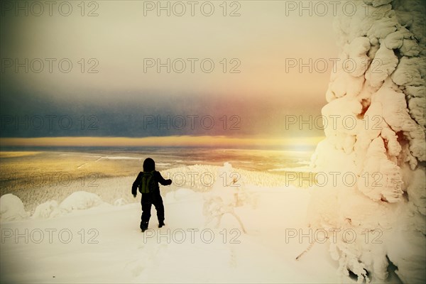 Hiker walking in snowy forest