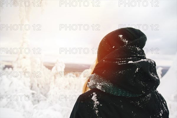 Hiker admiring view of snowy landscape