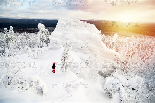 Hiker walking on snowy mountaintop