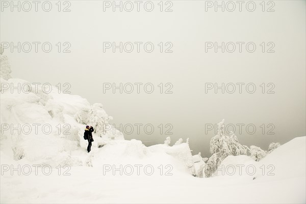 Hiker walking in snowy forest