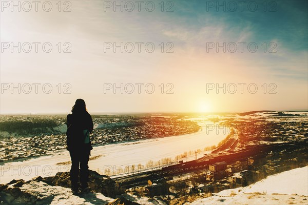 Hiker admiring cityscape view from mountain