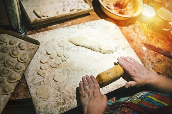 Woman rolling meat dumplings