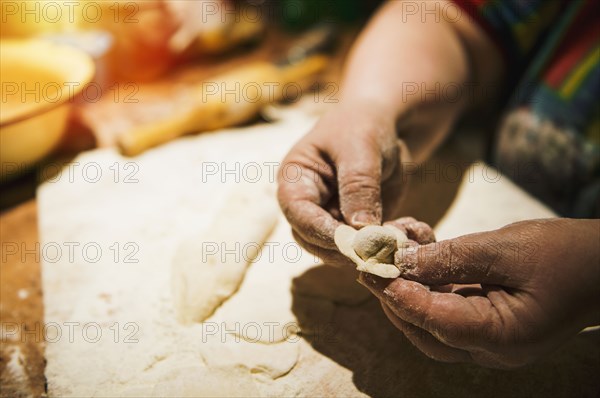 Close up of woman forming meat dumplings