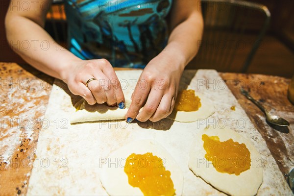 Close up of woman forming dumplings