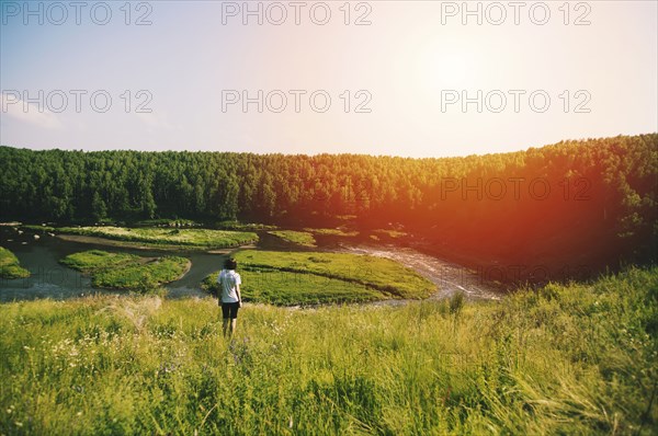 Caucasian woman on hill over remote river