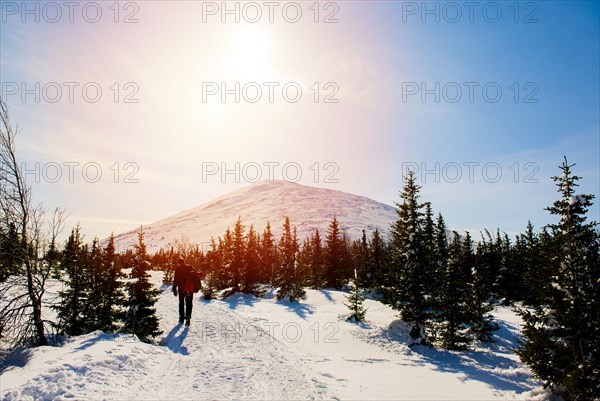 Man hiking on mountain in winter