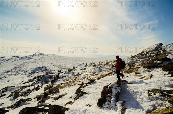 Man hiking on mountain in winter