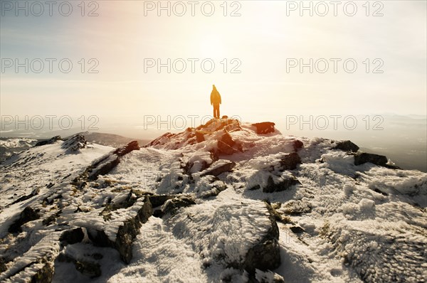Woman hiking on mountain in winter