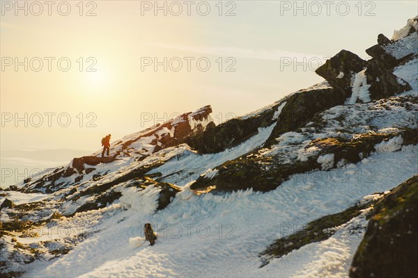 Man hiking on mountain in winter