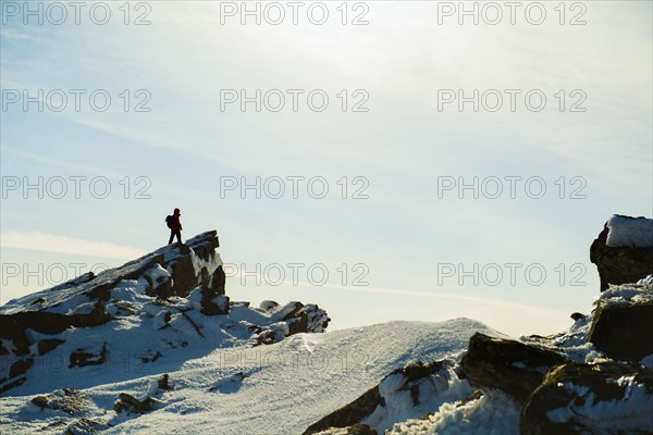 Man hiking on mountain in winter