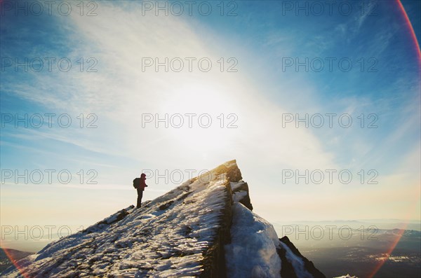 Man hiking on mountain in winter