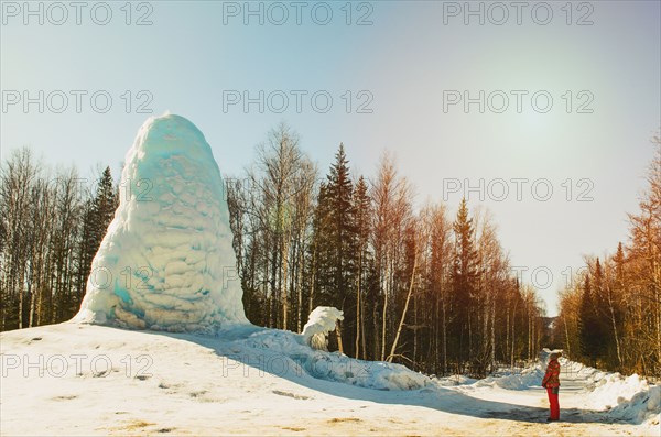 Woman admiring pile of snow in winter