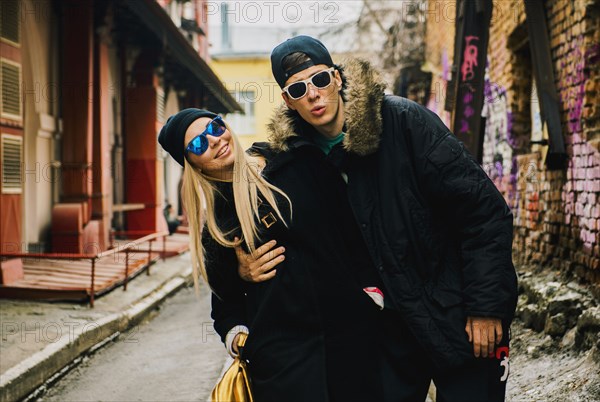 Couple hugging in urban alley